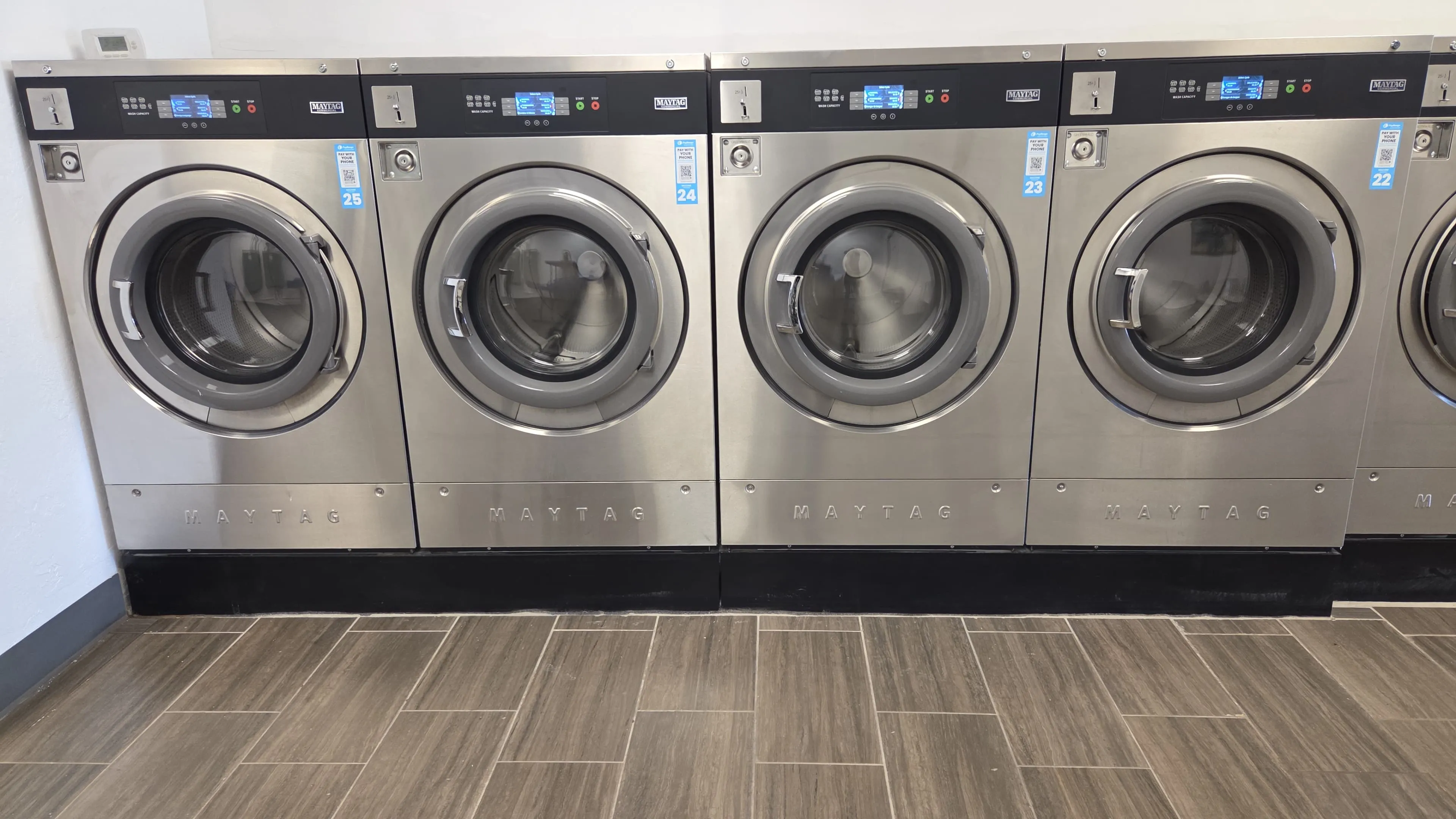 High-capacity commercial washing machines for bulk laundry loads.